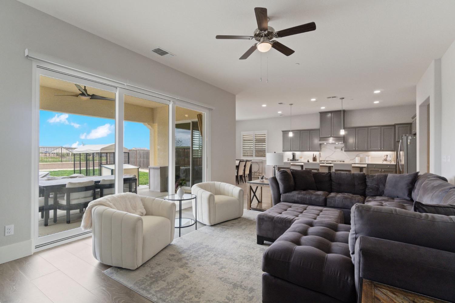 4491 Vineyard Drive Madera, CA 93636 - Photo 9 of 47 a living room with furniture kitchen view and a large window