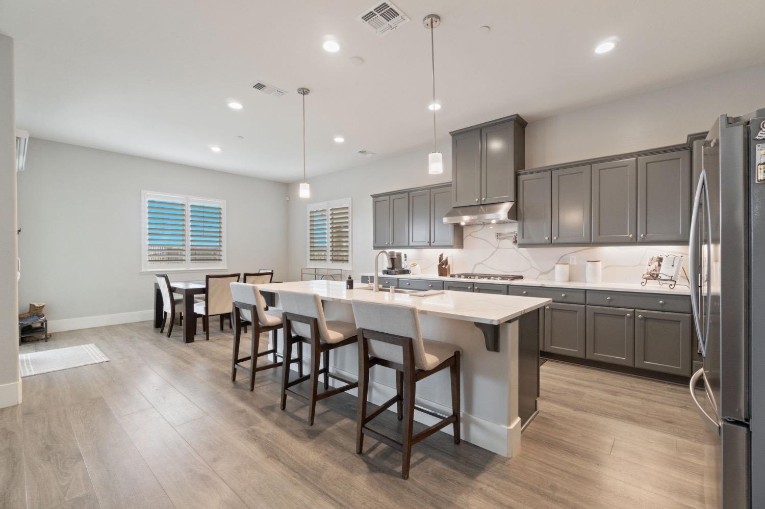 4491 Vineyard Drive Madera, CA 93636 - Photo 10 of 47 a large kitchen with a table and chairs