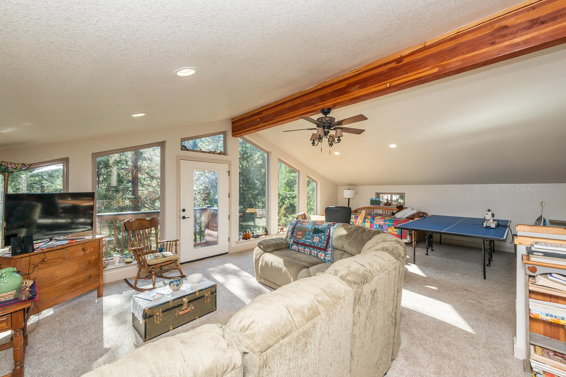 851 Mountain Aire Road Trinity Center, CA 96091 - Photo 29 of 54 a living room with furniture a flat screen tv and a large window