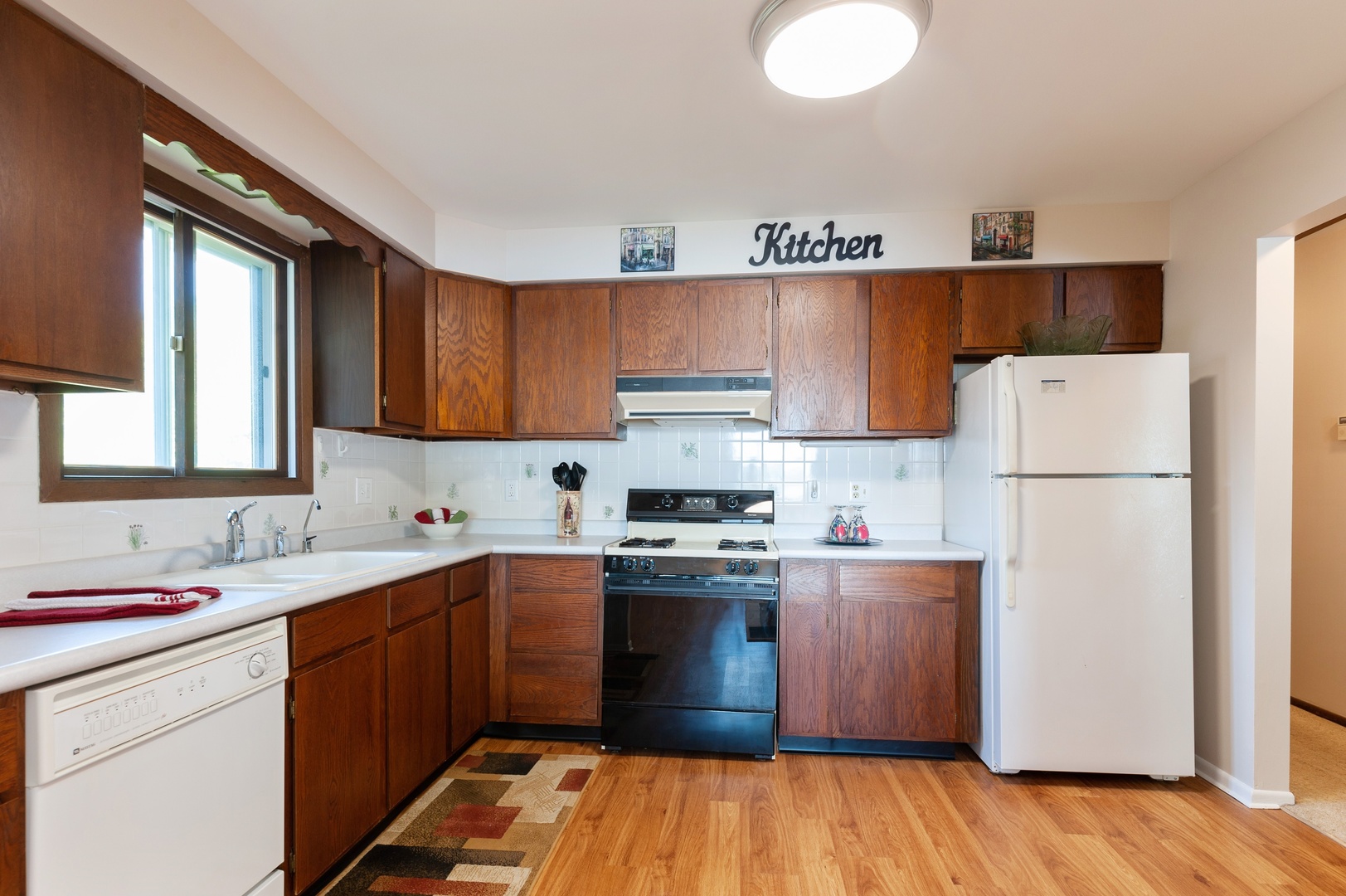 209 North Rushmore Road Fox Lake, IL 60020 - Photo 11 of 21 a kitchen with a sink a stove a refrigerator and cabinets