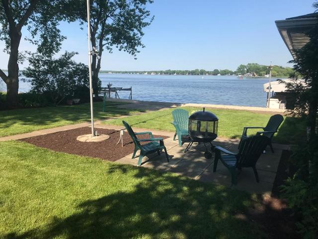 209 North Rushmore Road Fox Lake, IL 60020 - Photo 16 of 21 a view of a patio with table and chairs under an umbrella
