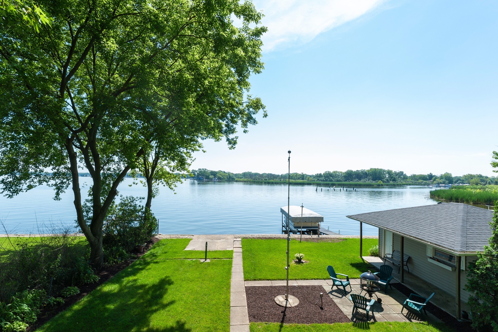 209 North Rushmore Road Fox Lake, IL 60020 - Photo 4 of 21 a view of a lake from a garden