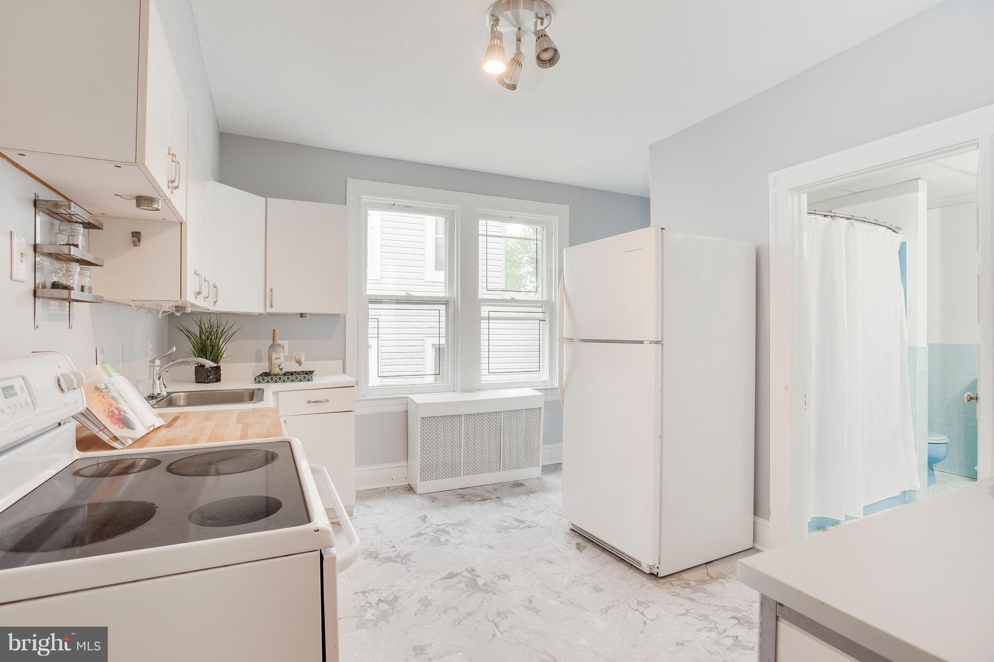 5316 Tramore Road Baltimore, MD 21214 - Photo 10 of 30 a kitchen with a refrigerator sink and cabinets