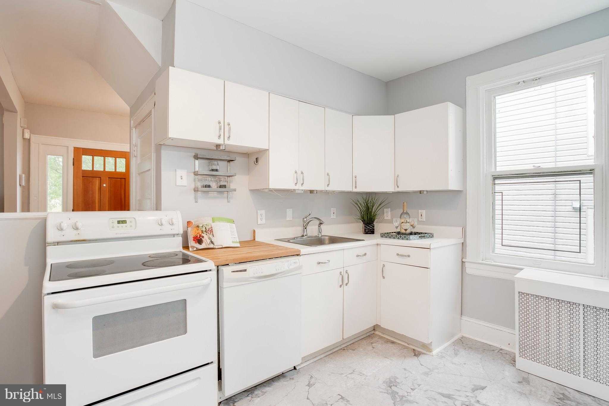 5316 Tramore Road Baltimore, MD 21214 - Photo 11 of 30 a kitchen with white cabinets sink and white appliances