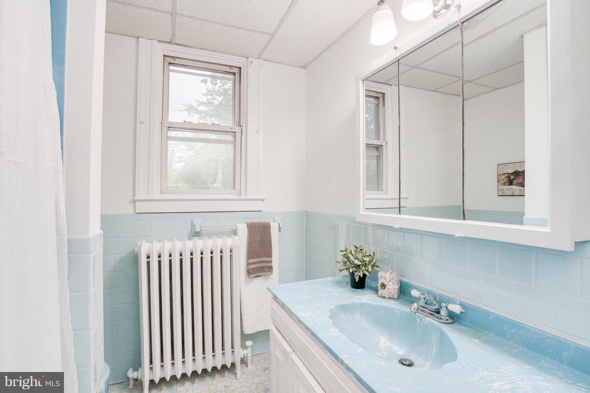 5316 Tramore Road Baltimore, MD 21214 - Photo 14 of 30 a bathroom with a sink and a window