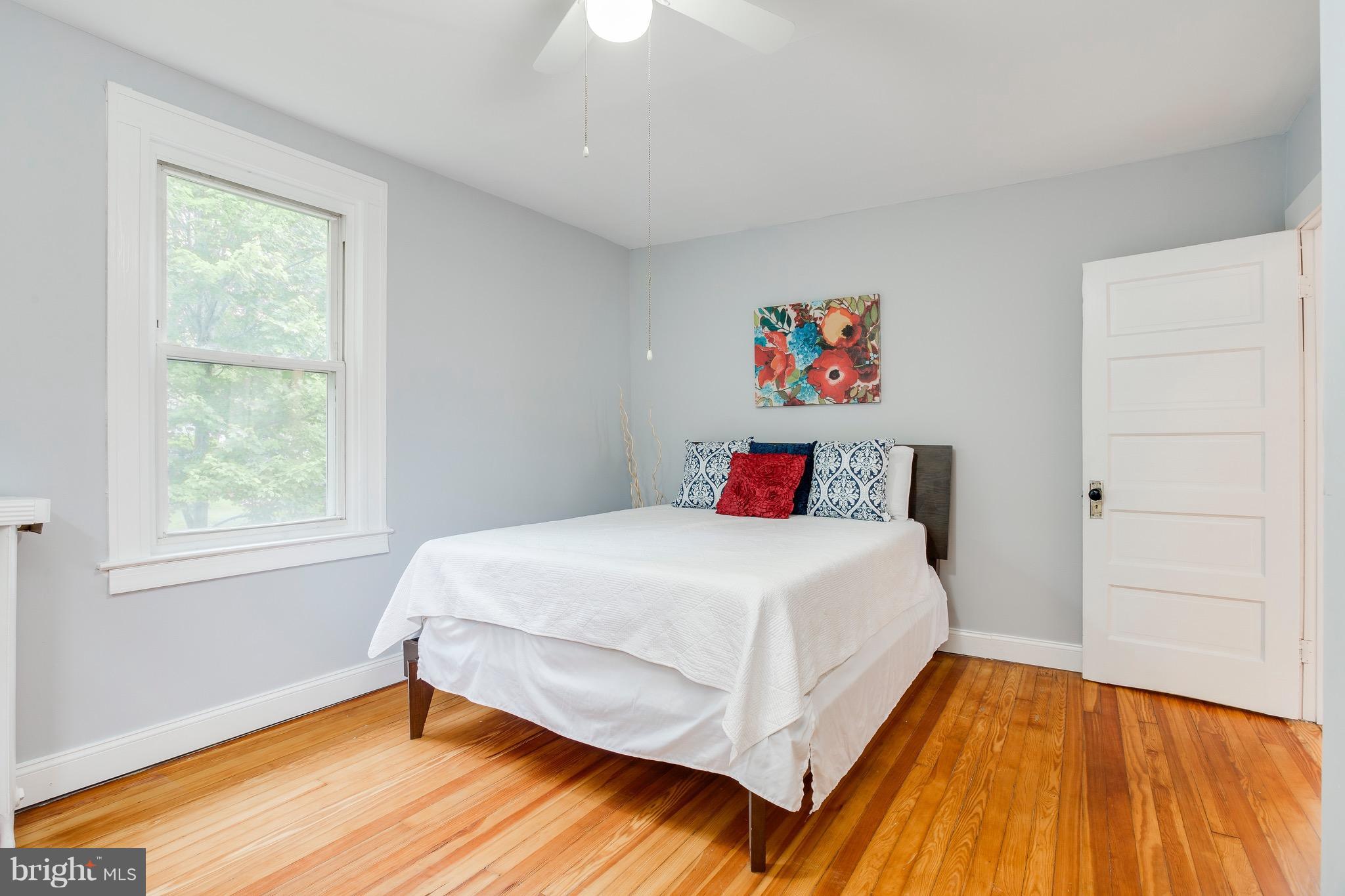 5316 Tramore Road Baltimore, MD 21214 - Photo 16 of 30 a bed sitting in a bedroom next to a window