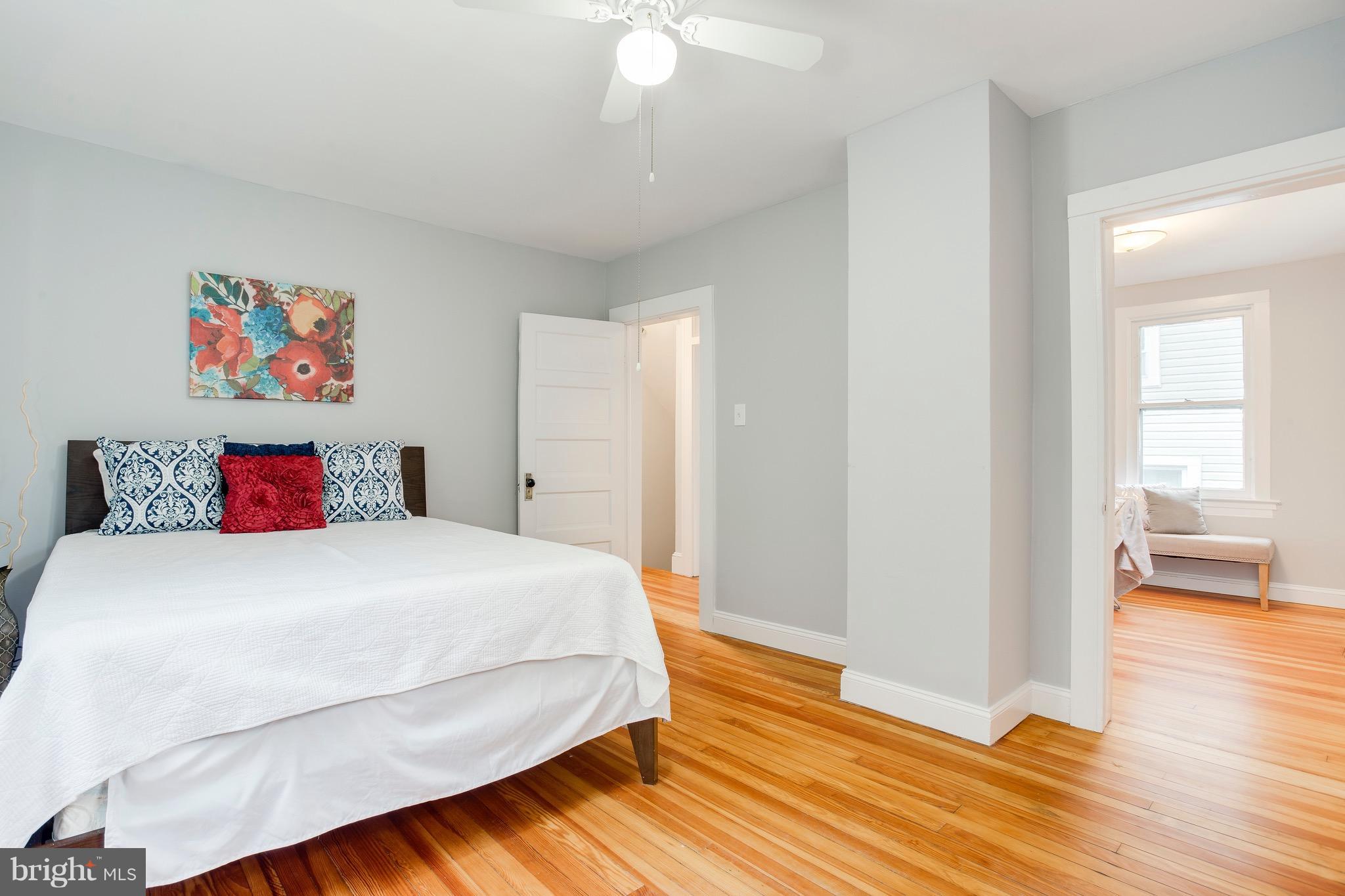 5316 Tramore Road Baltimore, MD 21214 - Photo 17 of 30 a bedroom with a bed and wooden floor