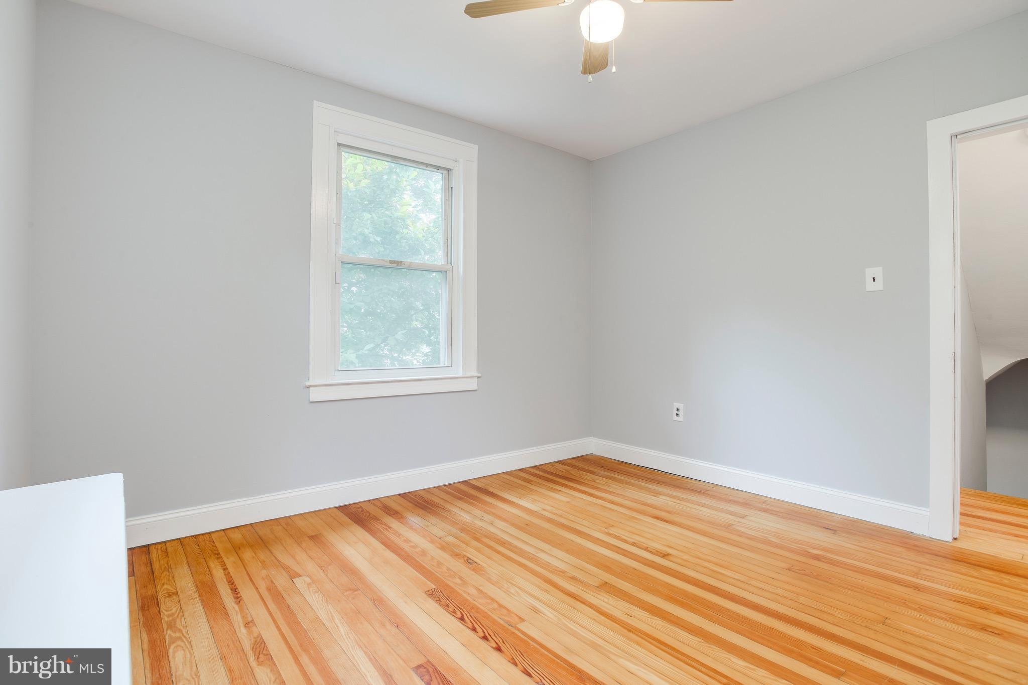 5316 Tramore Road Baltimore, MD 21214 - Photo 19 of 30 a view of empty room with wooden floor and fan