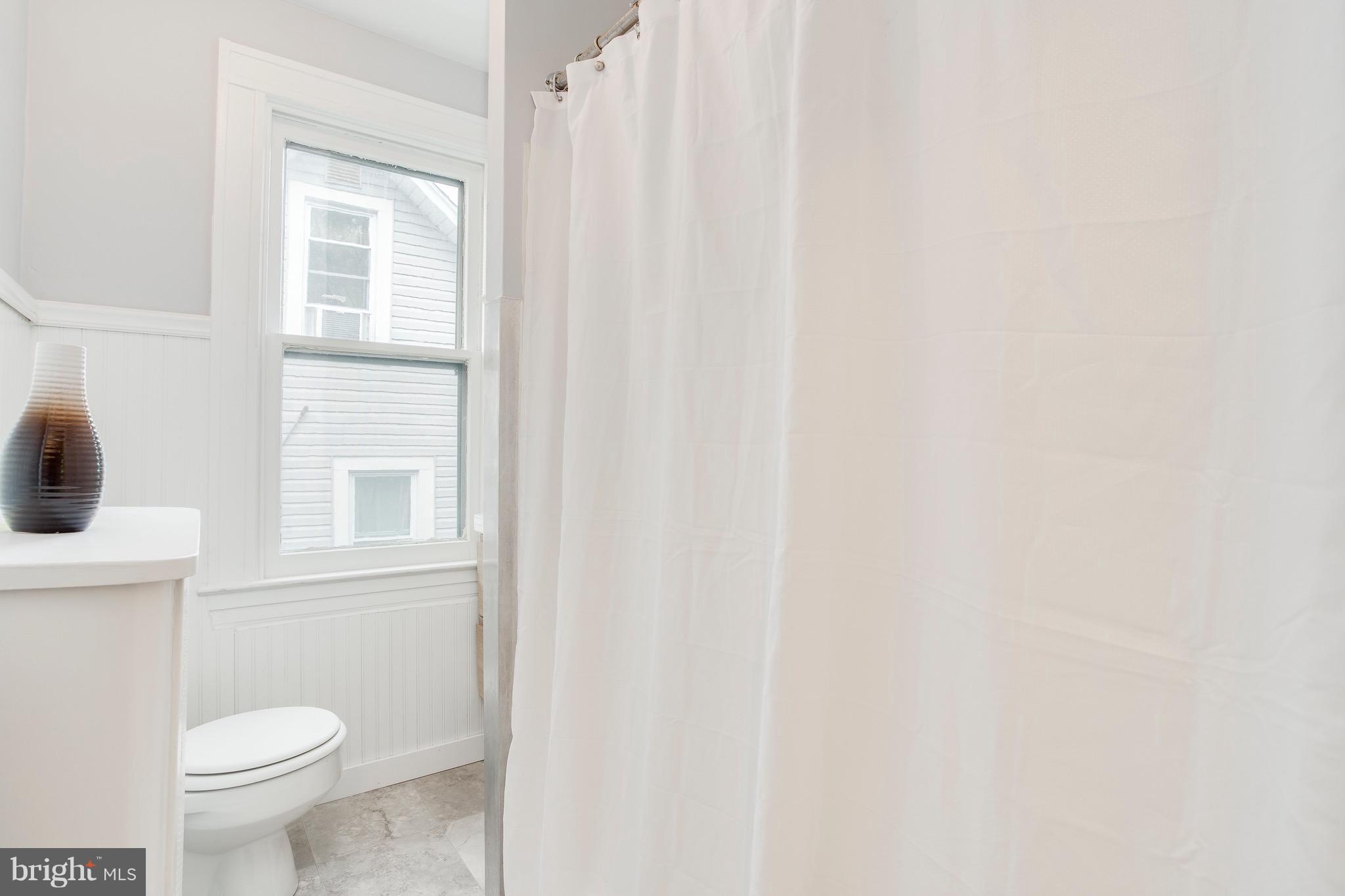 5316 Tramore Road Baltimore, MD 21214 - Photo 20 of 30 a bathroom with a toilet a sink and a window