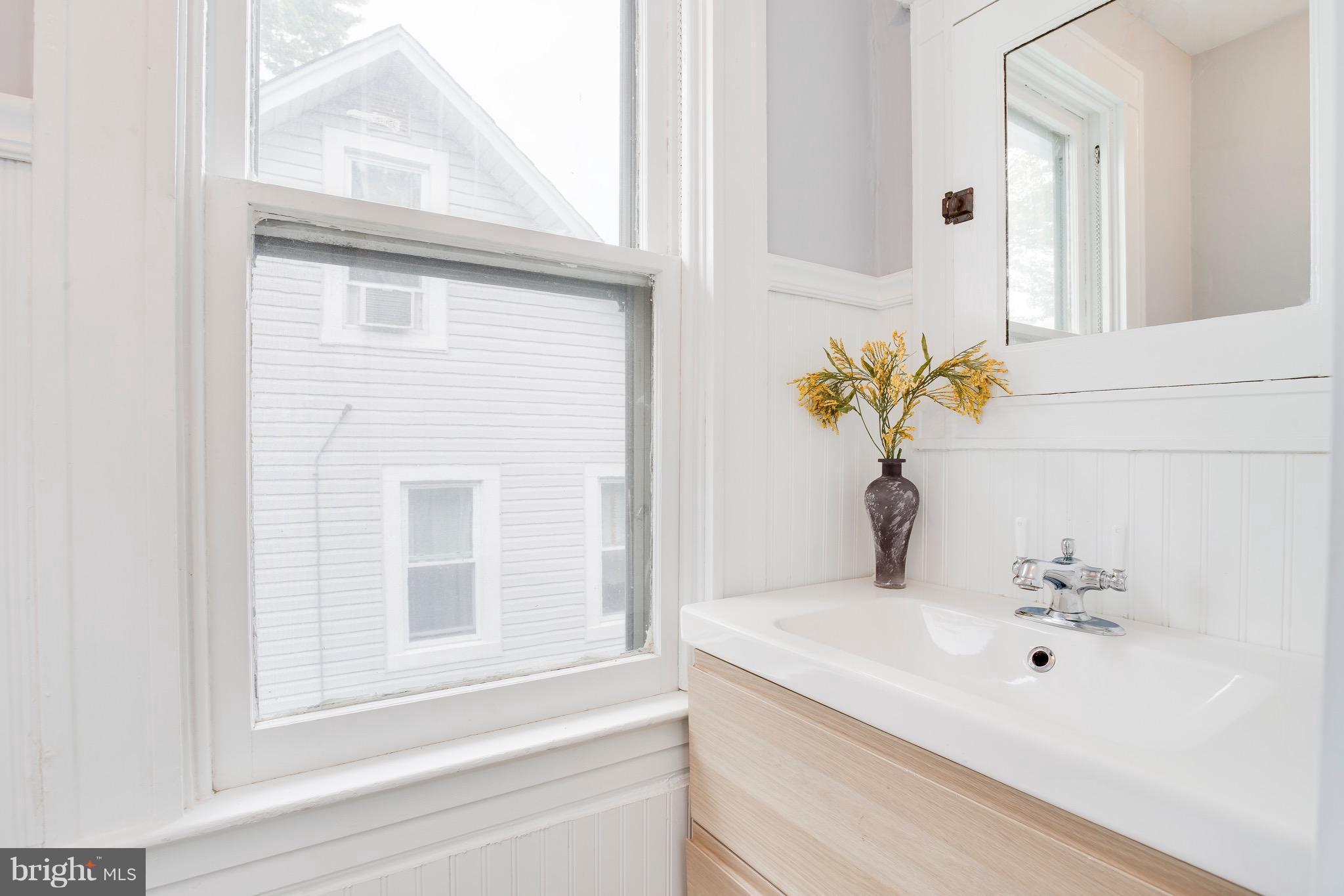 5316 Tramore Road Baltimore, MD 21214 - Photo 21 of 30 a bathroom with a sink and a mirror