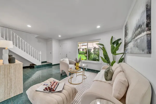 a living room with furniture and a potted plant