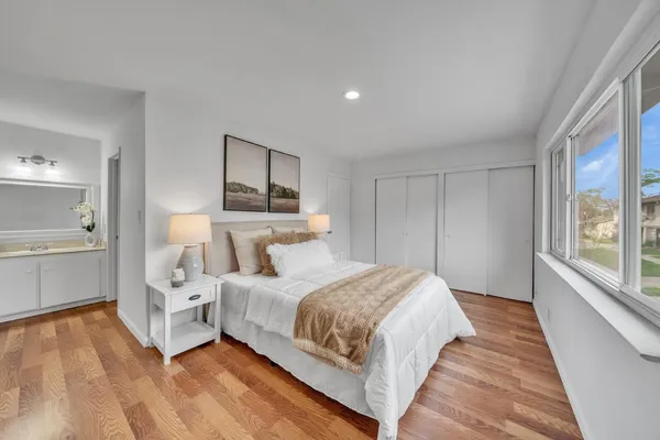 a bedroom with a bed and a large window