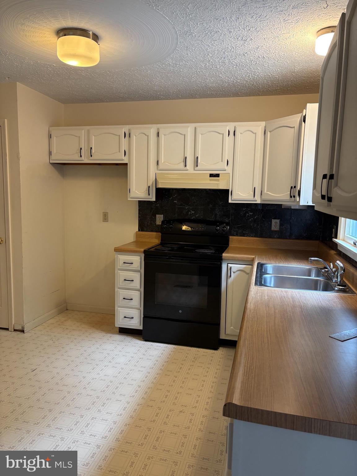 2865 Capon Springs Road High View, WV 26808 - Photo 6 of 34 a kitchen with stainless steel appliances granite countertop a stove a sink and a refrigerator