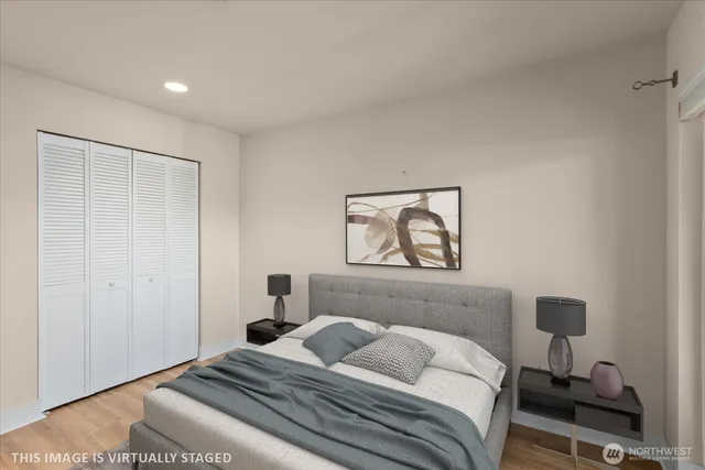 a bedroom with a bed and a night stand