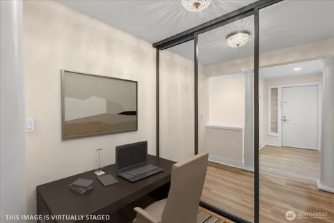 a view of a workspace with furniture and wooden floor