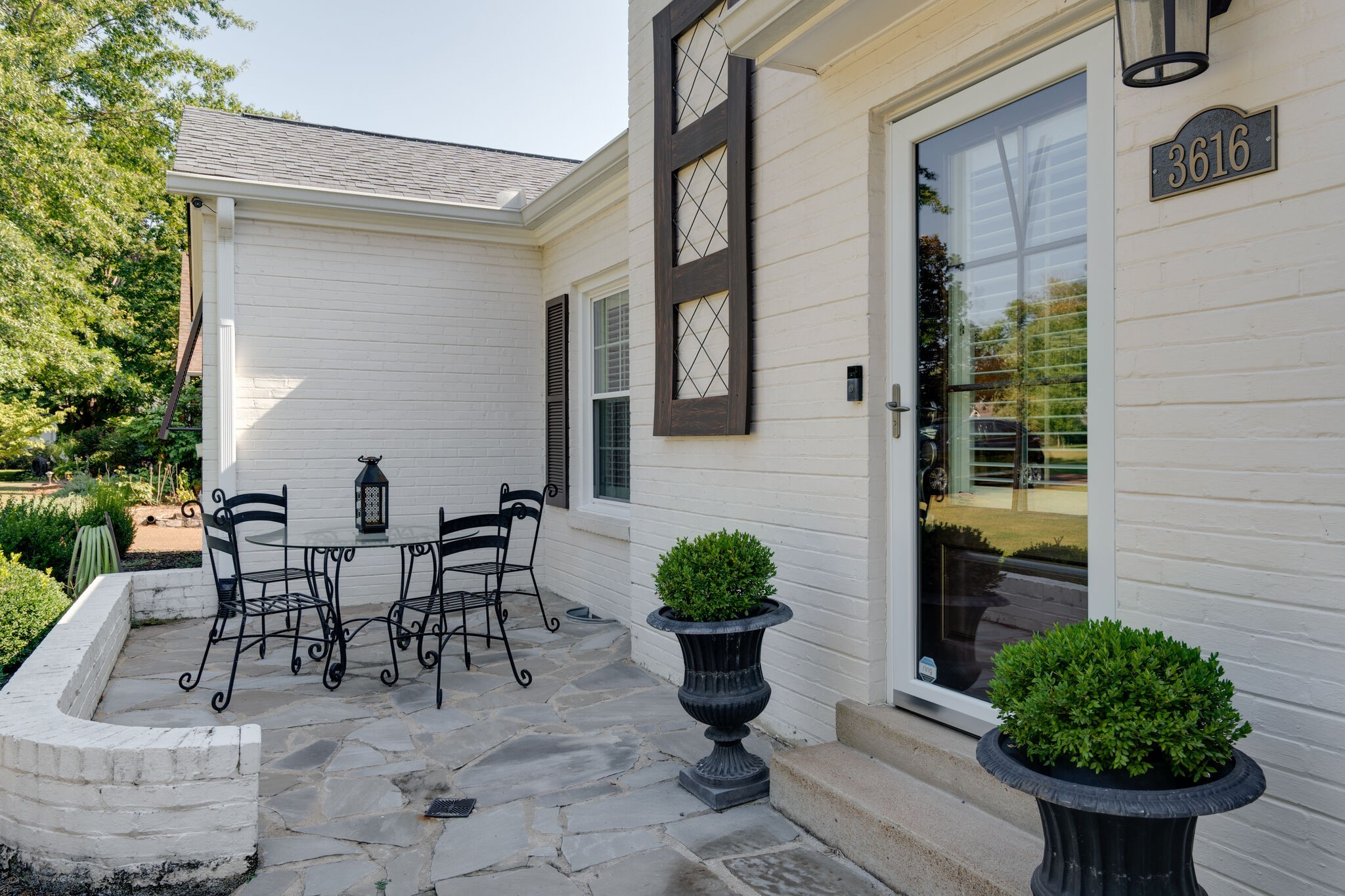 Undisclosed Address Nashville, TN 37204 - Photo 4 of 24 a view of a patio with table and chairs and potted plants