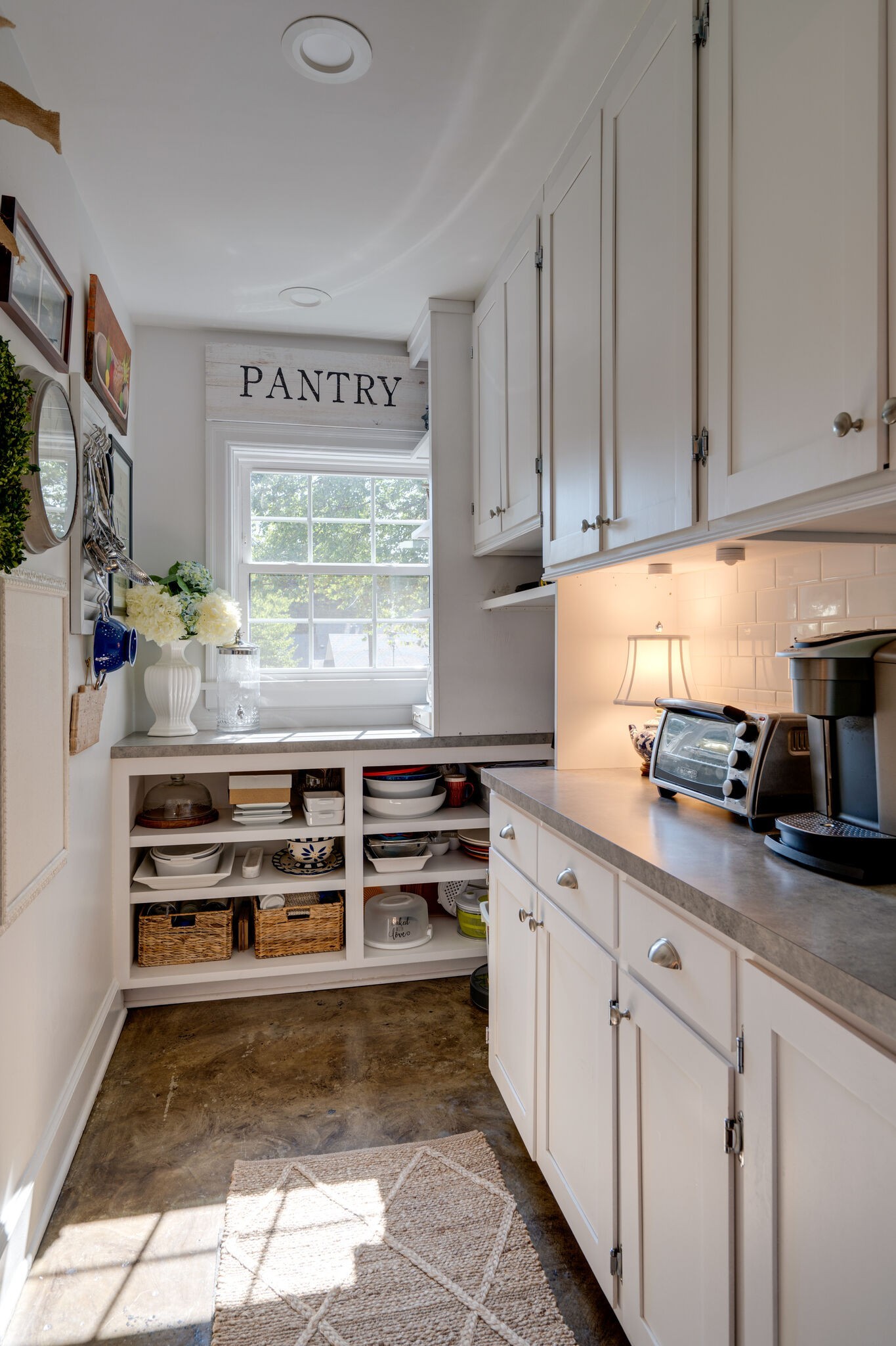 Undisclosed Address Nashville, TN 37204 - Photo 10 of 24 a kitchen with stainless steel appliances a stove and white cabinets