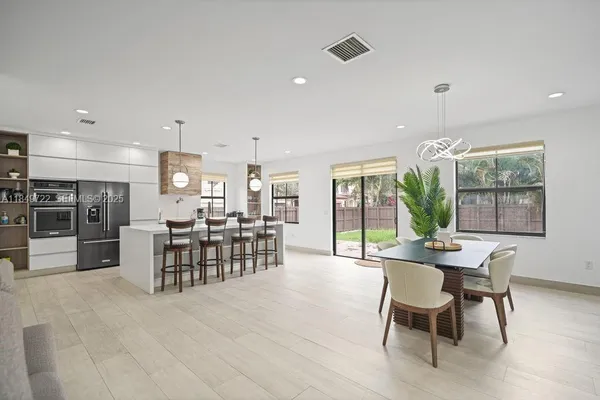 a dining room with furniture window garden view