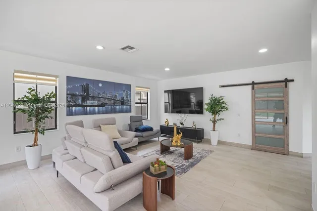 a living room with furniture and a potted plant