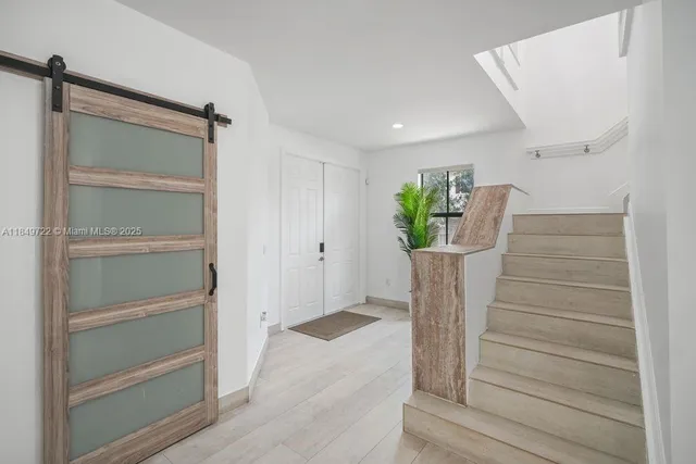 a view of staircase with white walls and a window