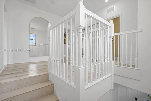 a view of staircase with white walls and a window