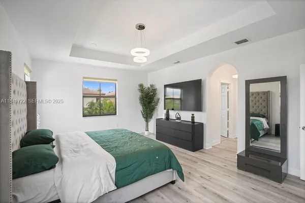 a bedroom with a bed and a couch