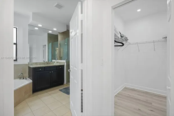 a bathroom with a double vanity sink a mirror and a shower