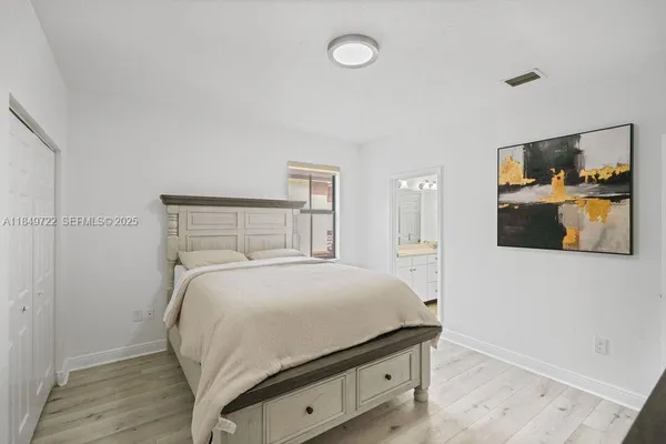 a bedroom with a bed and a television