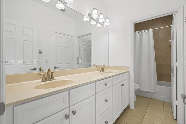 a bathroom with a sink double vanity and a mirror