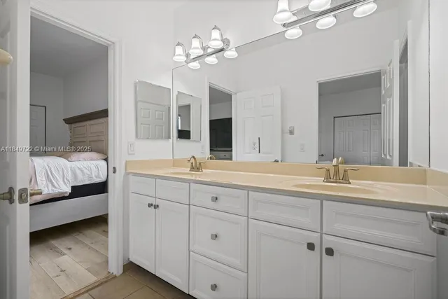 a bedroom with a bed and a night stand