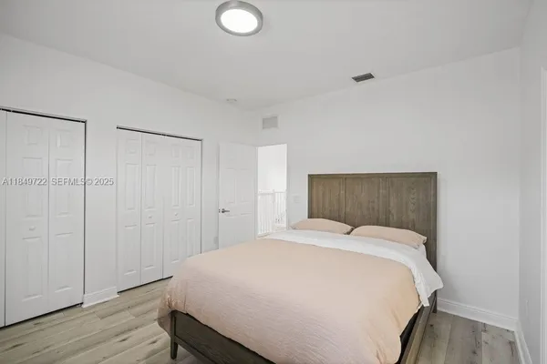 a bedroom with a bed and a night stand