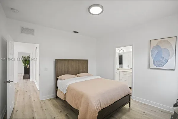 a bed room with a bed and a lamp