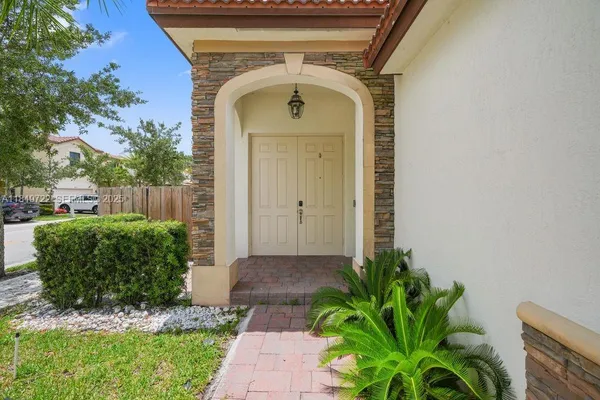 a front view of a house with garden