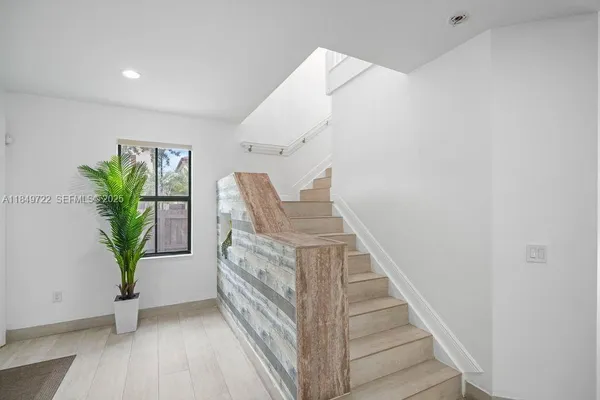 a view of entryway with livingroom and wooden floor