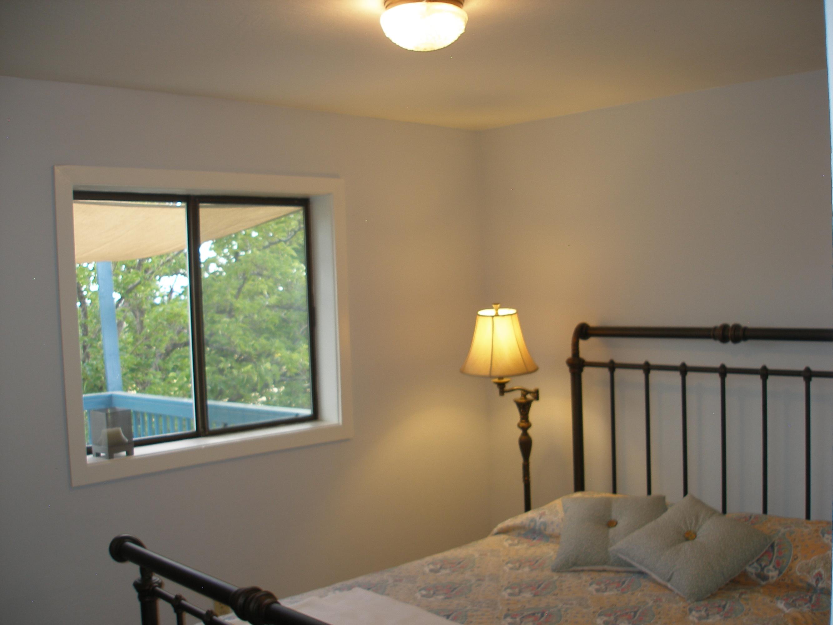 32135 Rock Creek Road Manton, CA 96059 - Photo 36 of 65 a bedroom with a bed and a lamp next to a window