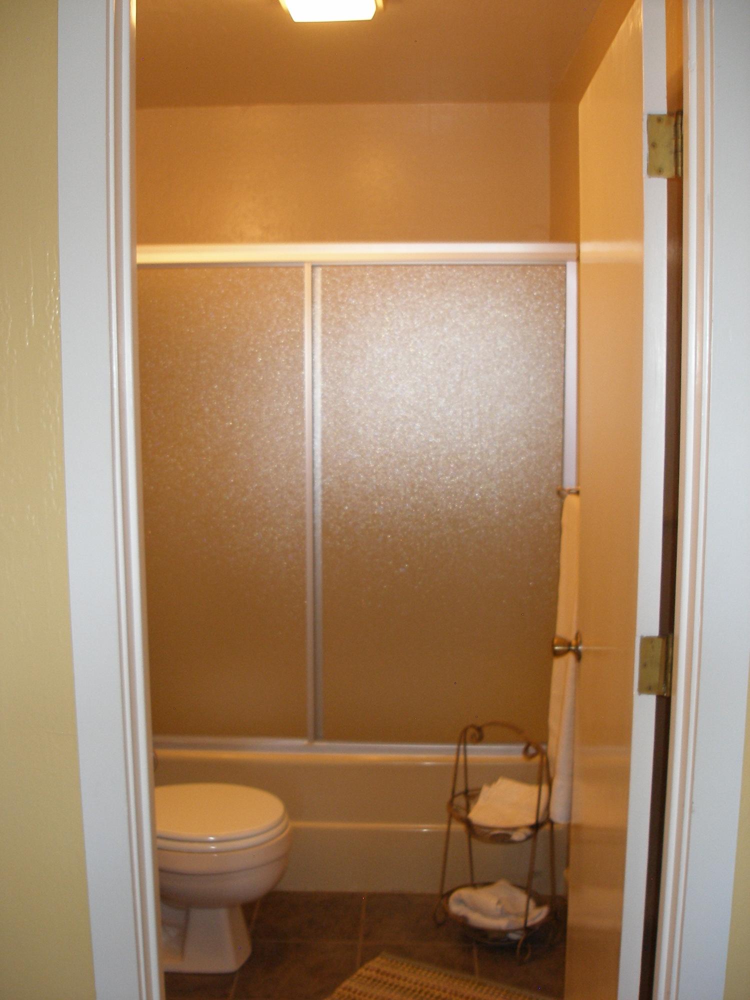 32135 Rock Creek Road Manton, CA 96059 - Photo 42 of 65 a bathroom with a toilet and a shower curtain