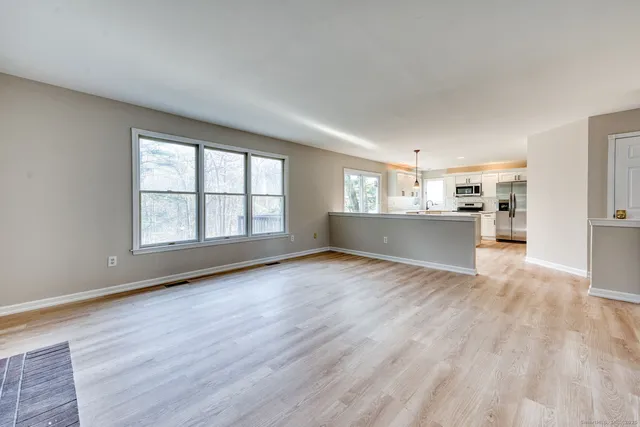 wooden floor in an empty room with a window
