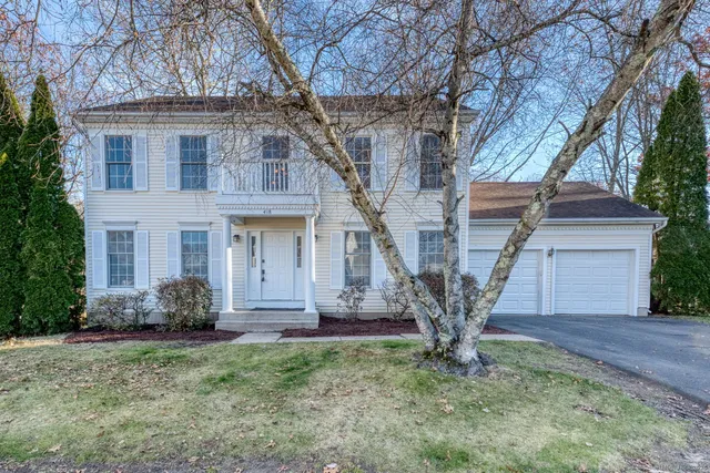 front view of a house with a tree