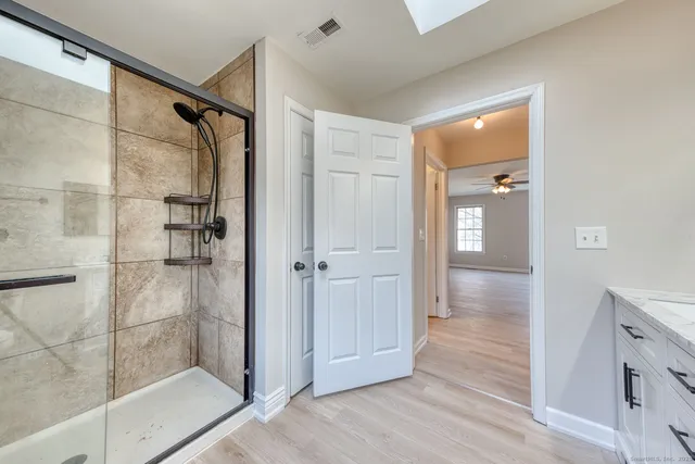 a bathroom with a glass shower door