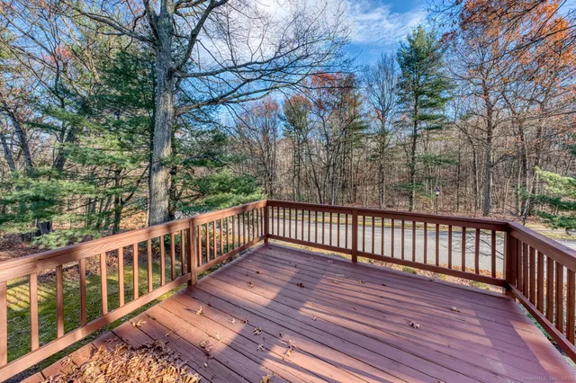 a view of balcony with wooden floor and fence