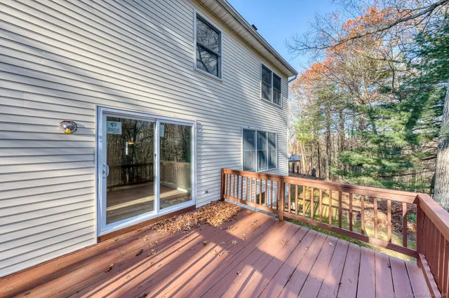 a view of a wooden deck with a yard