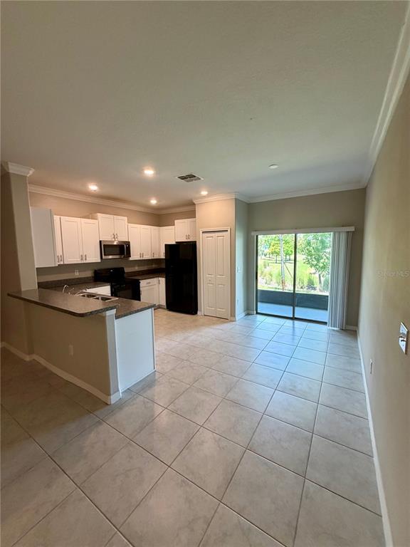 11826 Dumaine Valley Road Riverview, FL 33579 - Photo 9 of 54 a large kitchen with stainless steel appliances granite countertop a stove a sink and a refrigerator