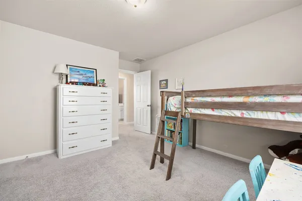 a view of a room with furniture and a ceiling fan