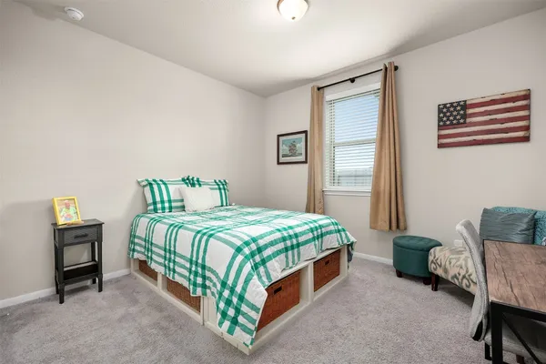 a bedroom with a bed and a couch