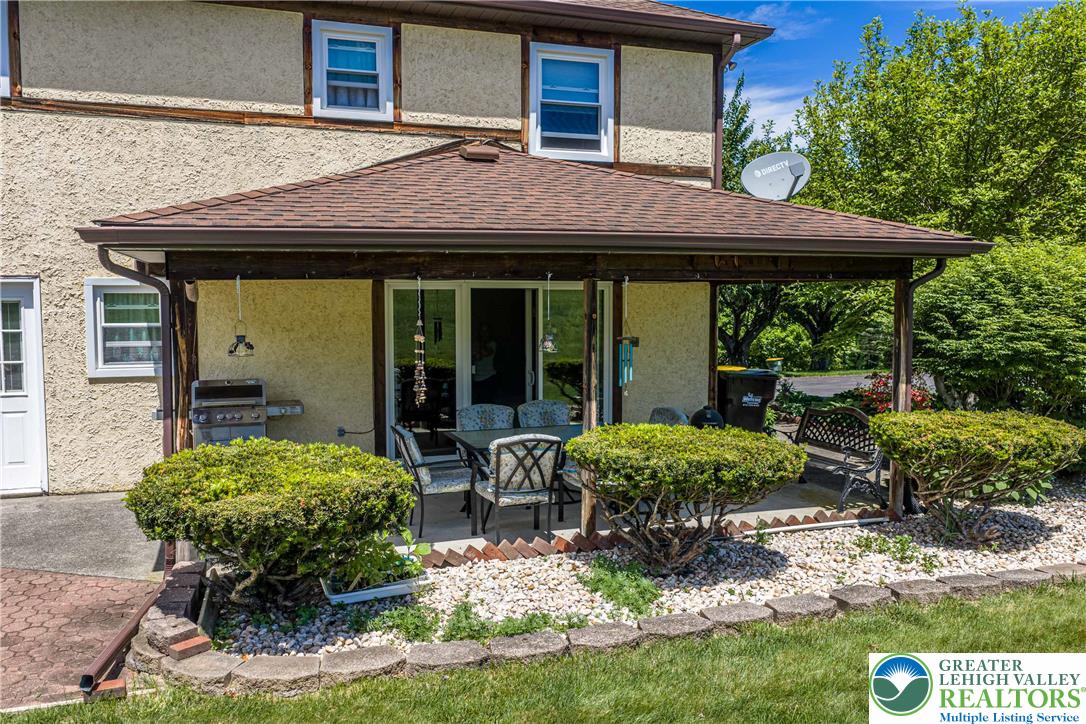 947 Tamenend Road Bath, PA 18014 - Photo 43 of 61 Relax in the serene outdoor living space, featuring a covered patio perfect for entertaining guests.