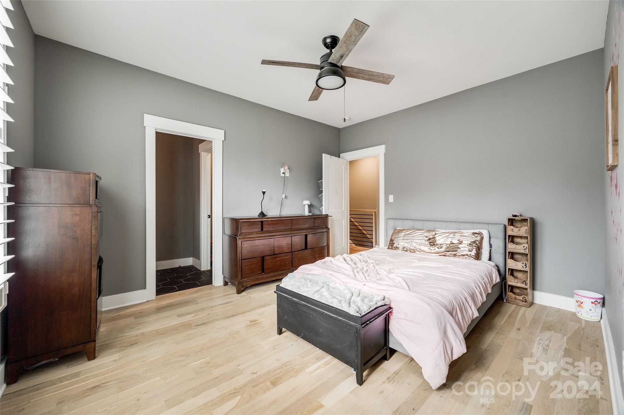 785 Ormand Road York, SC 29745 - Photo 26 of 46 a spacious bedroom with a bed and a chandelier