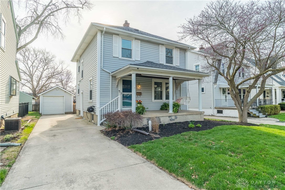 This classic two-story home features a welcoming covered porch, perfect for outdoor relaxation.