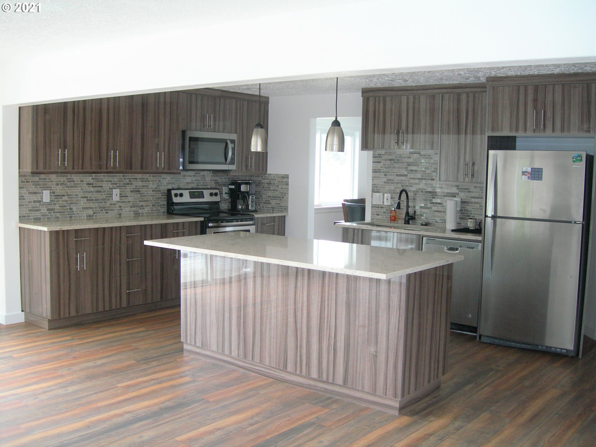 3310 Northeast 162nd Street Ridgefield, WA 98642 - Photo 3 of 13 a kitchen with stainless steel appliances a refrigerator and a sink
