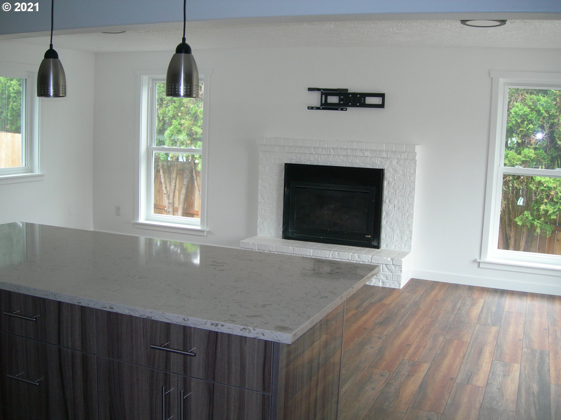3310 Northeast 162nd Street Ridgefield, WA 98642 - Photo 7 of 13 a view of an empty room with wooden floor and a window