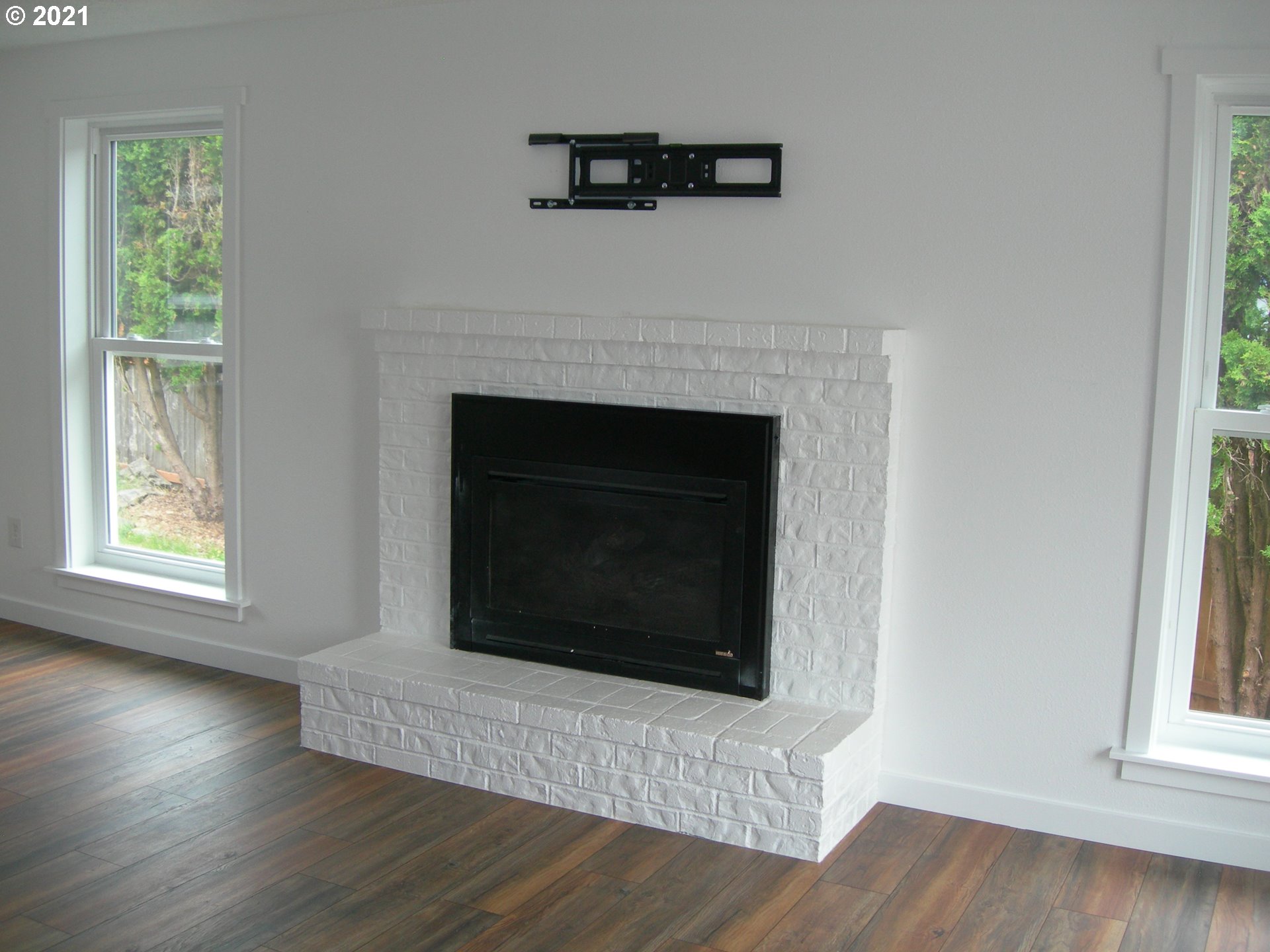 3310 Northeast 162nd Street Ridgefield, WA 98642 - Photo 8 of 13 a living room with a fireplace with wooden floor